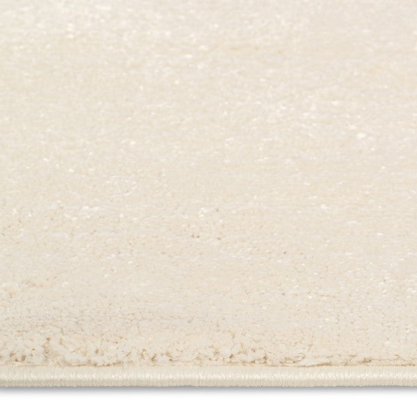 Close-up of the Dreamy Arc Kids Rug showing its soft-touch ivory pile texture.