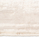 Close-up of the short delicate fringe and soft distressed pile on the cream and beige Elara soft-touch rug.