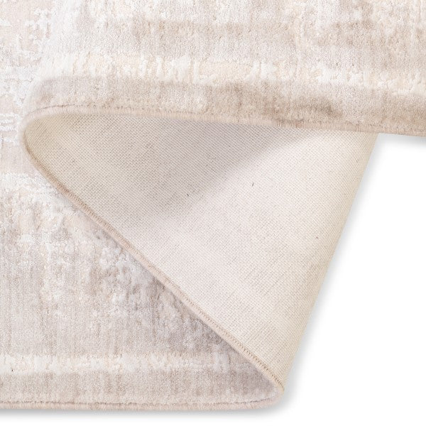 Folded corner of the Elara distressed rug showing the plush soft-touch surface and sturdy woven backing.
