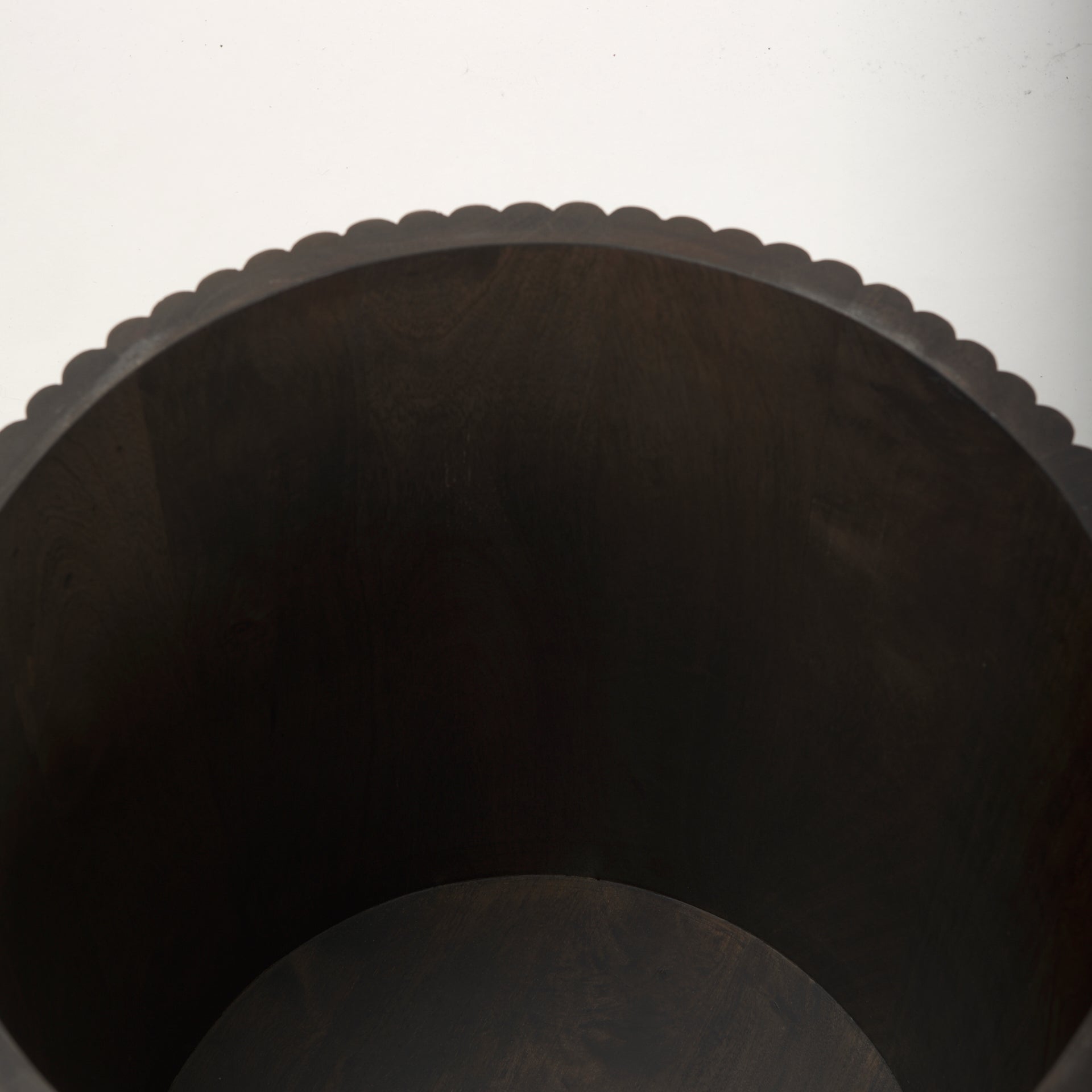 Top-down view inside the empty drum of the dark wood Eleanor fluted side table, showcasing its deep storage capacity.
