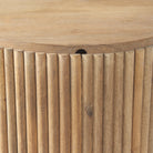 Close-up of the vertical fluted wood detailing and the smooth edge of the lid on the Eleanor mango wood side table.
