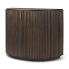 Angled view of the closed Eleanor dark mango wood accent cabinet featuring fluted details and brass pulls.