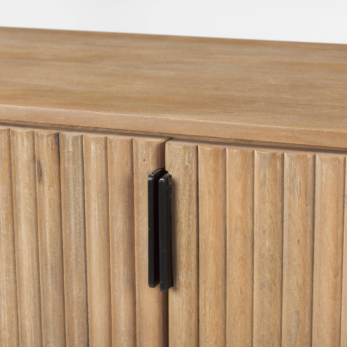 Macro detail of the textured fluted doors and matte black vertical hardware on the light wood Eleanor sideboard