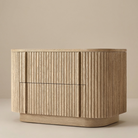 Angled front view of the Elias Oak Nightstand showing the natural oak finish and fluted drawers