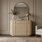 Elias ribbed wood dresser styled in a modern home with a gold mushroom lamp and abstract art, highlighting the warm oak finish and soft curved edges.