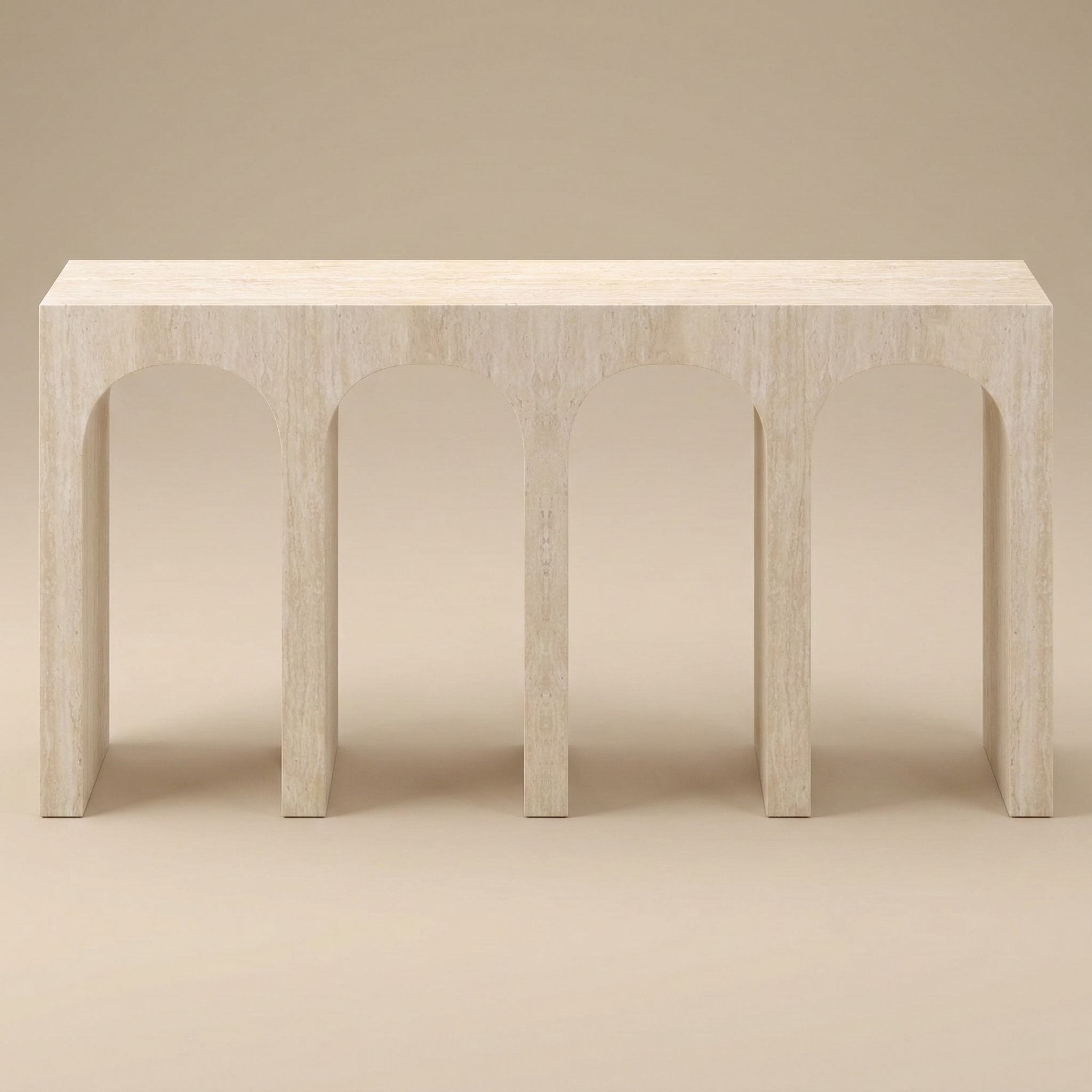 Elio Travertine Console Table in a matte beige finish, featuring repeating architectural archway cutouts shown from an angled perspective.