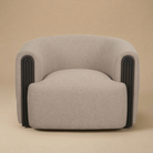 Full front view of the Elodie barrel chair in dark beige textured fabric with arched black fluted wood accents.