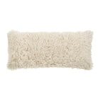 Beige fluffy rectangular pillow on a white background