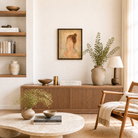 Cozy living room with wooden furniture, a round stone table, and decorative items.