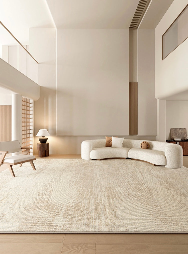 Grace Rug styled in a modern neutral living room with curved cream sofa, wooden accents, and soft beige textured pattern