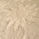 Close-up of textured beige fabric with floral patterns