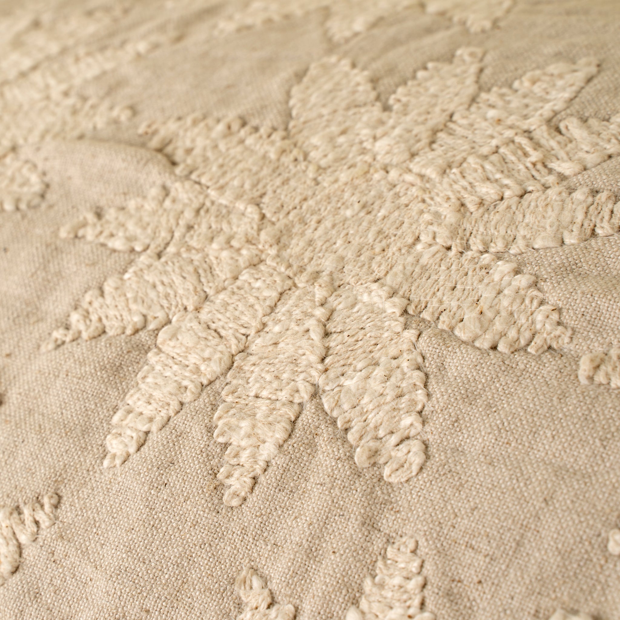 Close-up of textured beige fabric with floral patterns