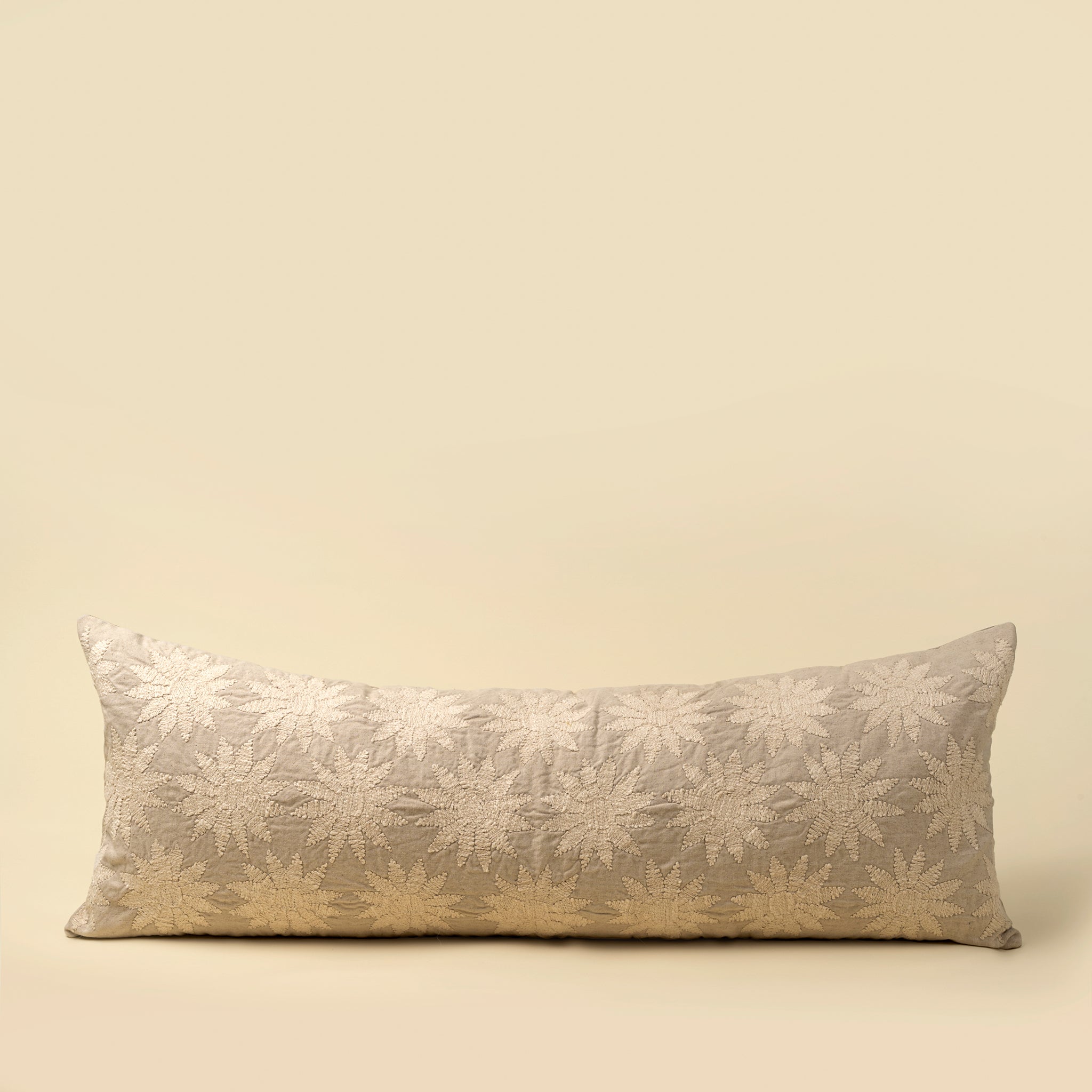 Decorative pillow with floral pattern on a beige background