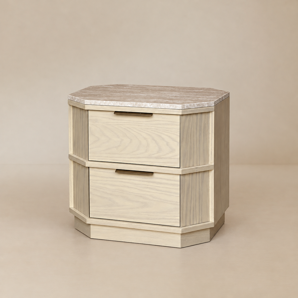 Three-quarter front view showing the two drawers, brass handles, chamfered corners, and natural yellow travertine top.