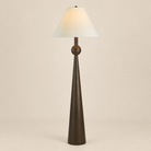 Inez Dark Walnut Floor Lamp featuring a sculptural painted dark walnut resin base and off-white linen shade on a seamless beige studio background.