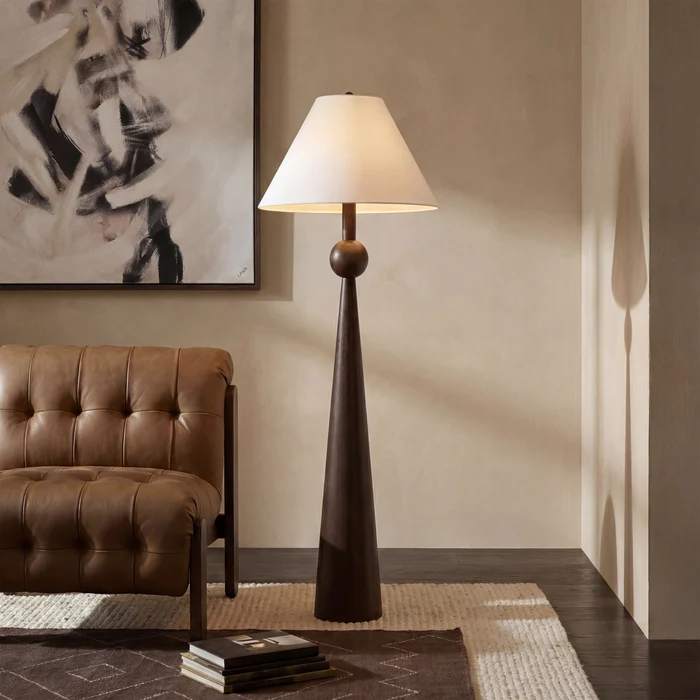 Inez Dark Walnut Floor Lamp styled beside a brown leather chair in a warm contemporary living room.