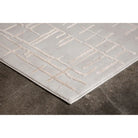 Gray rug with geometric pattern on a dark floor