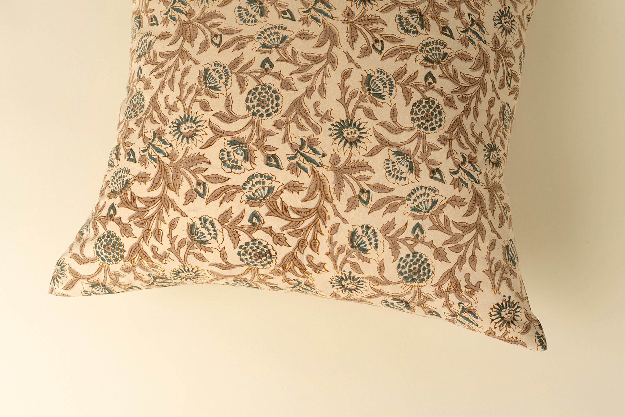 Decorative pillow with floral pattern on a beige background