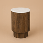 Kaia wooden side table with a white marble top on a beige background