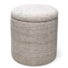 Round storage ottoman with textured fabric on a white background