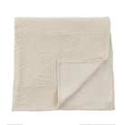 Beige quilted blanket on a white background