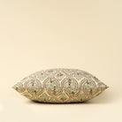 Decorative pillow with intricate pattern on a beige background