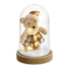 Lighted holiday bear under a glass cloche on a wooden base