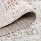 Folded corner of the Lennox distressed abstract rug showing its soft top pile and durable woven backing.