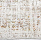 Close-up of the distressed abstract grid pattern featuring cream, grey, and rust tones on the Lennox area rug.