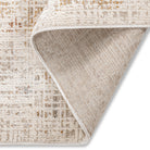 Corner view of the Lennox distressed abstract rug highlighting its tidy bound edges and modern artistic pattern.