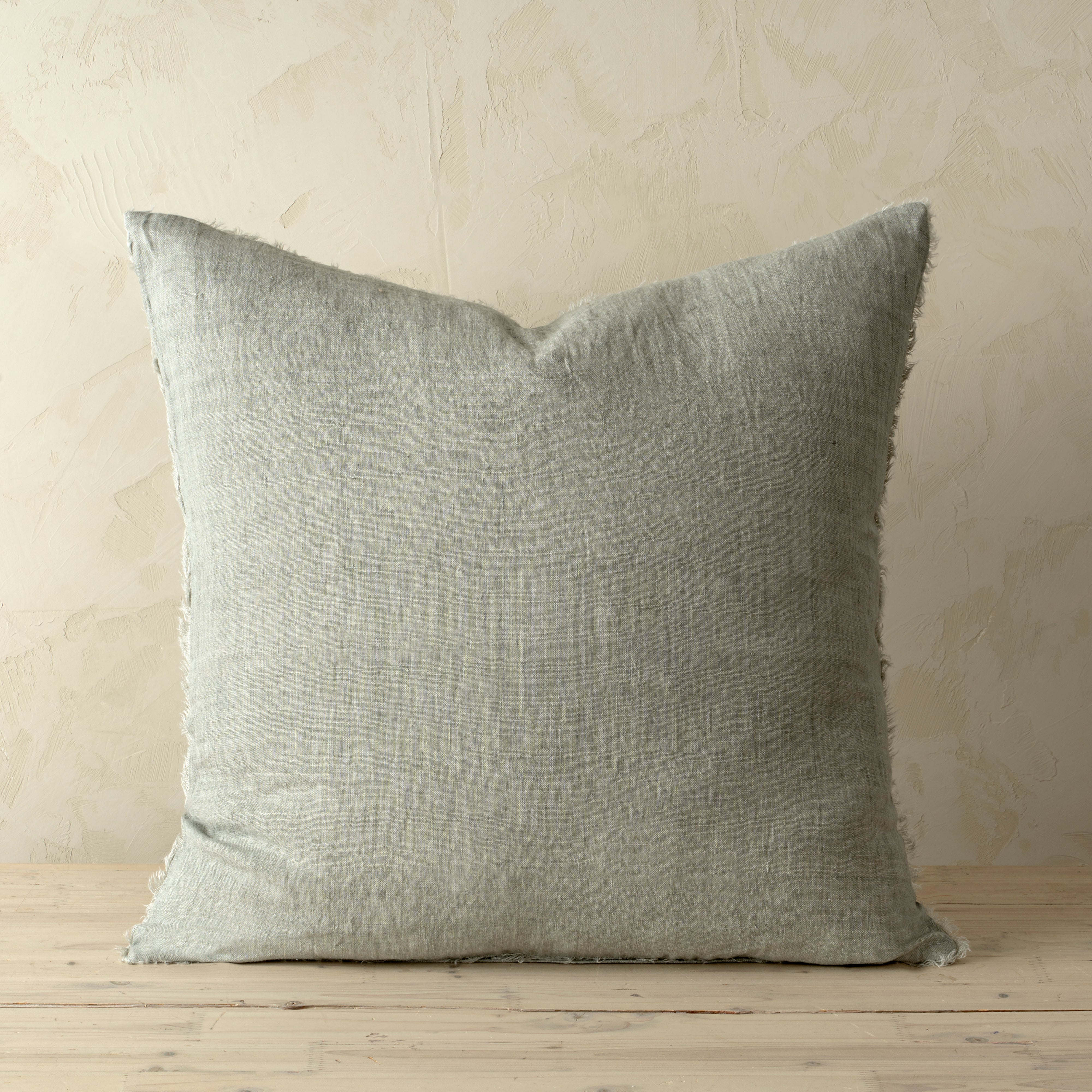 Full front view of the Lina linen pillow featuring a natural raw-edge fringe detail.