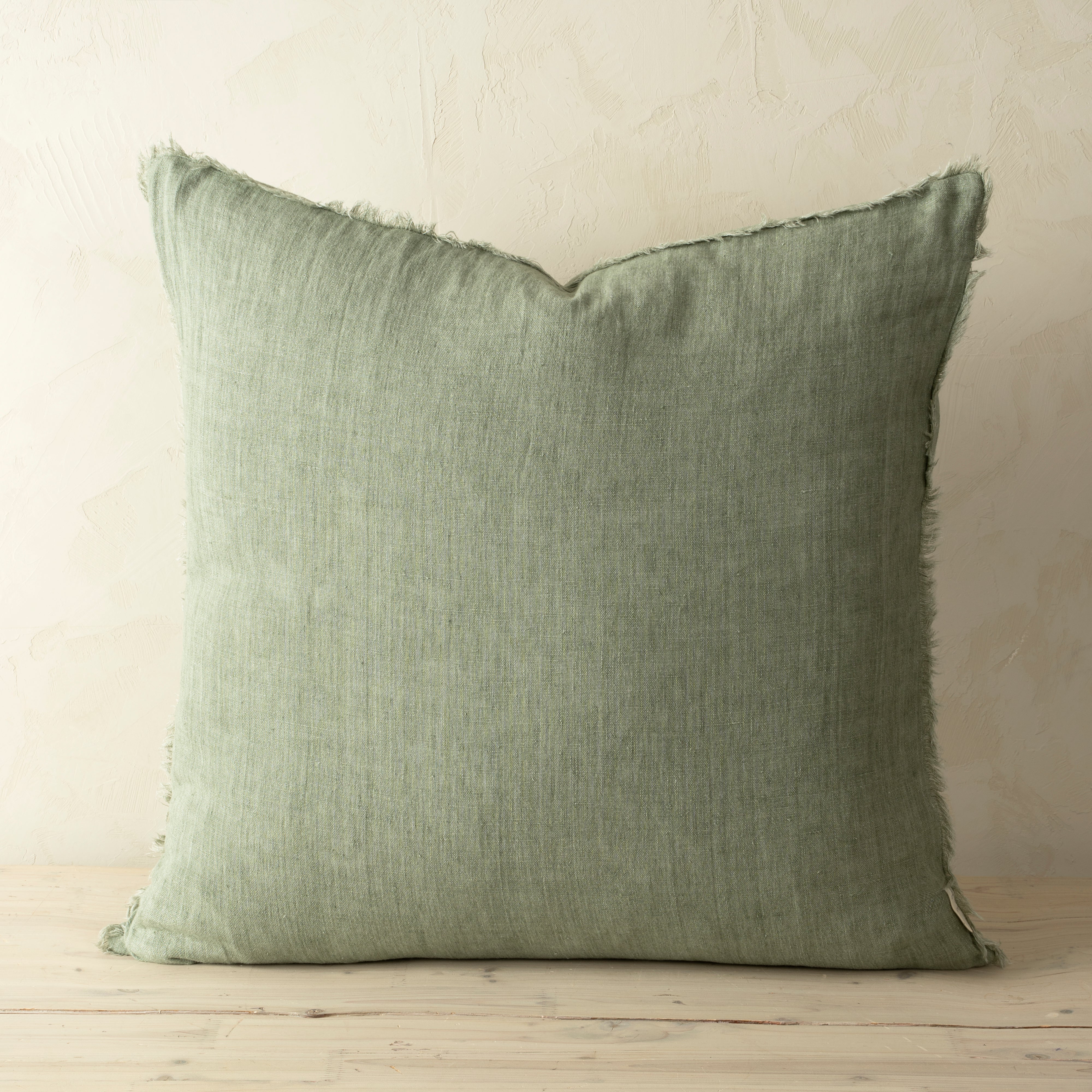 Full front view of the Lina linen pillow featuring a natural raw-edge fringe detail.