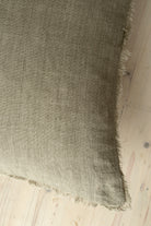 Macro close-up of the Lina linen pillow showcasing the breathable fabric and the delicate frayed fringe edge