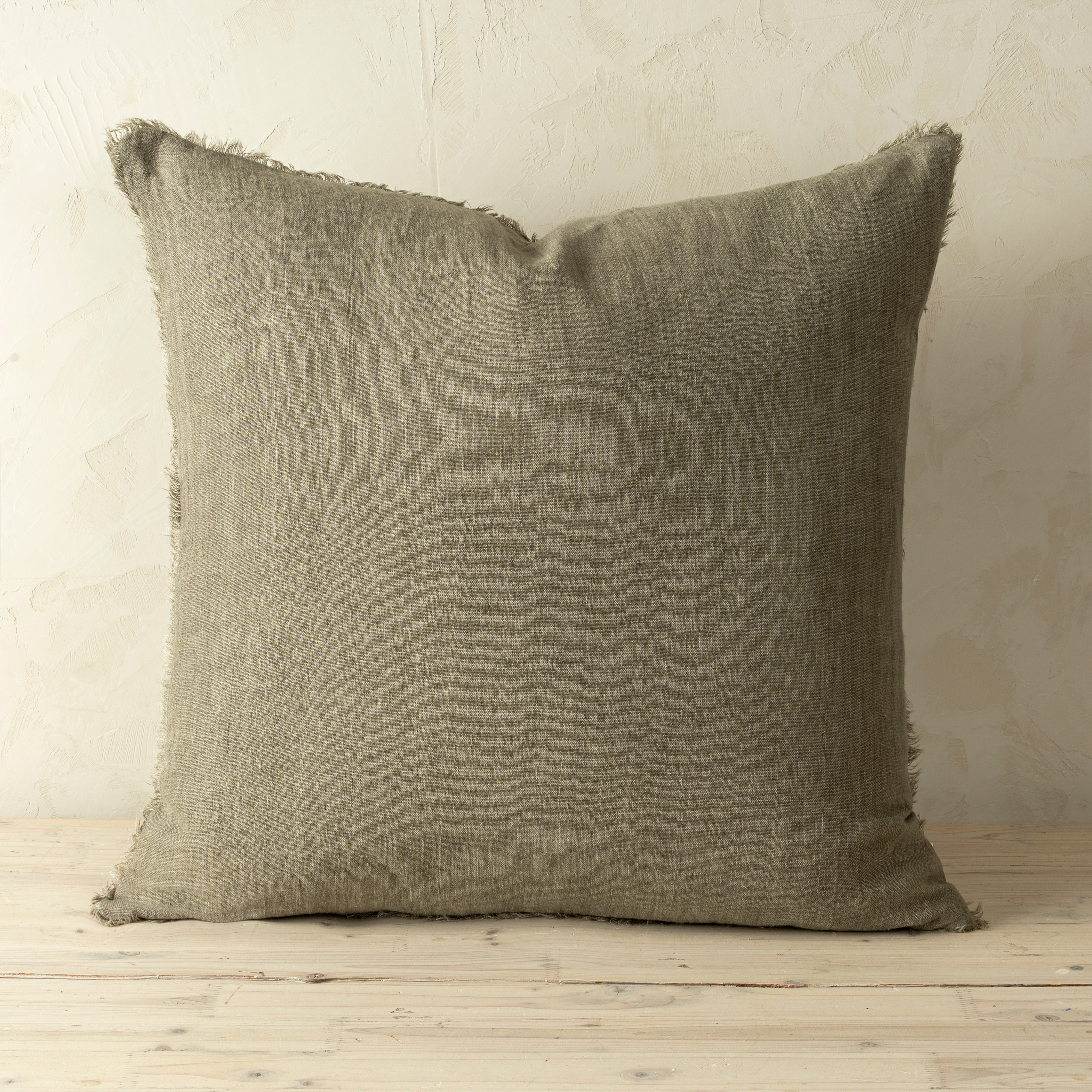 Full front view of the Lina linen pillow featuring a natural raw-edge fringe detail.