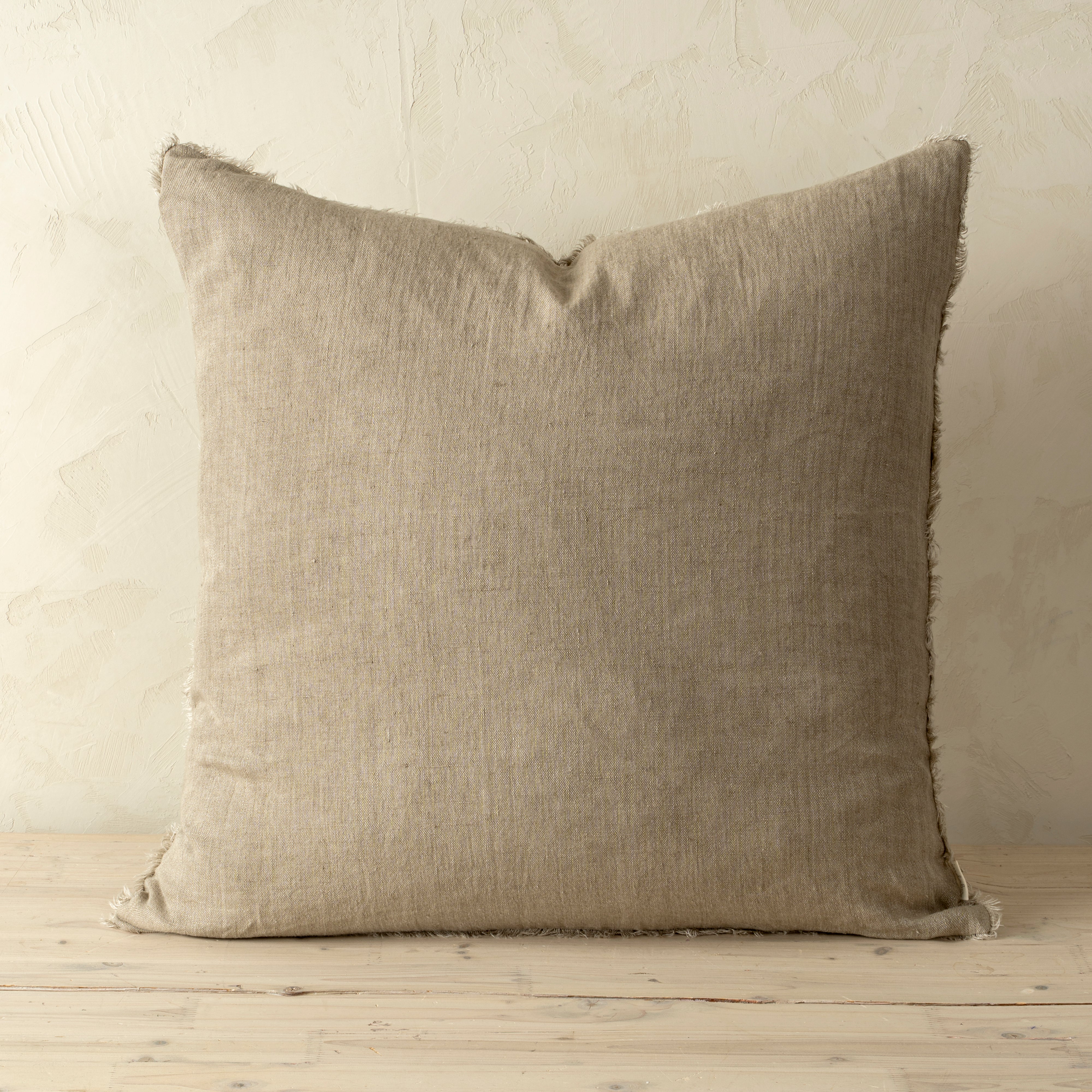 Full front view of the Lina linen pillow featuring a natural raw-edge fringe detail.