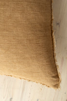 Macro close-up of the Lina linen pillow showcasing the breathable fabric and the delicate frayed fringe edge