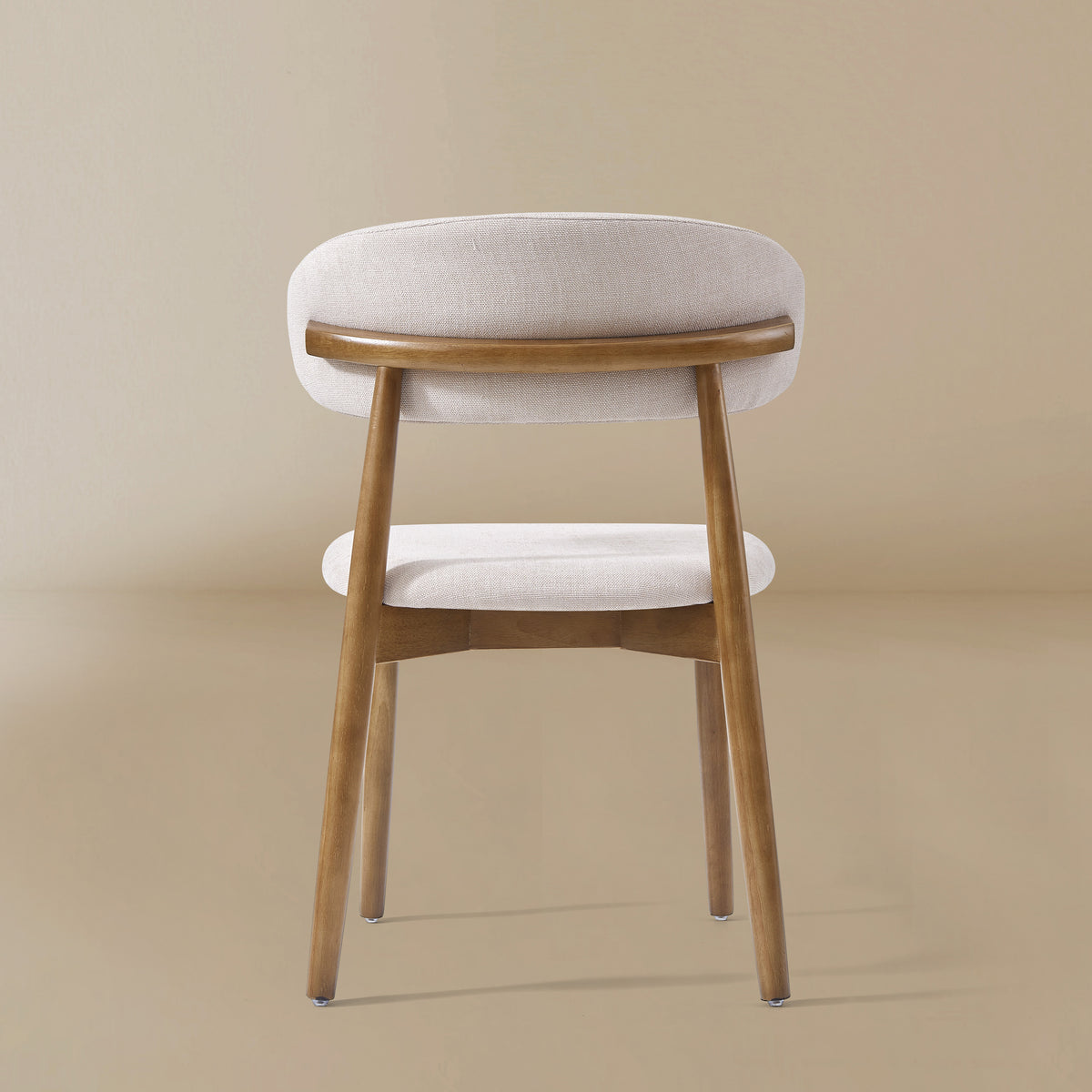Back profile of the Linen Ash Wood Dining Side Chairs with curved upholstered backs and ash wood frames, shown in a neutral studio setting