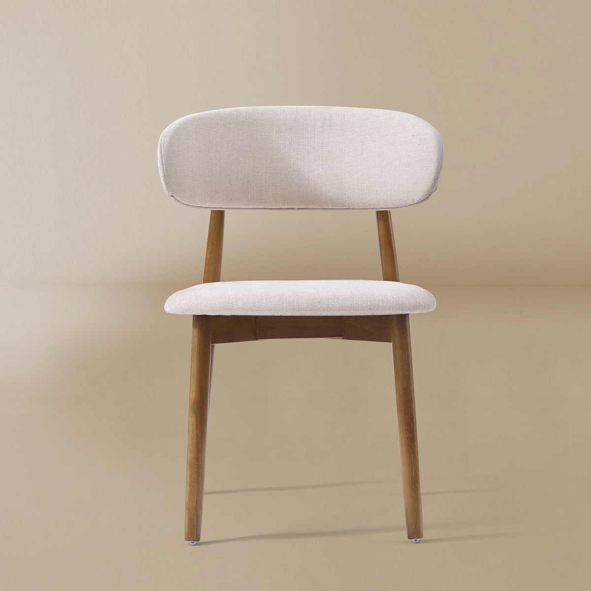 Linen Ash Wood Dining Side Chairs with curved upholstered backs and ash wood frames, shown in a neutral studio setting