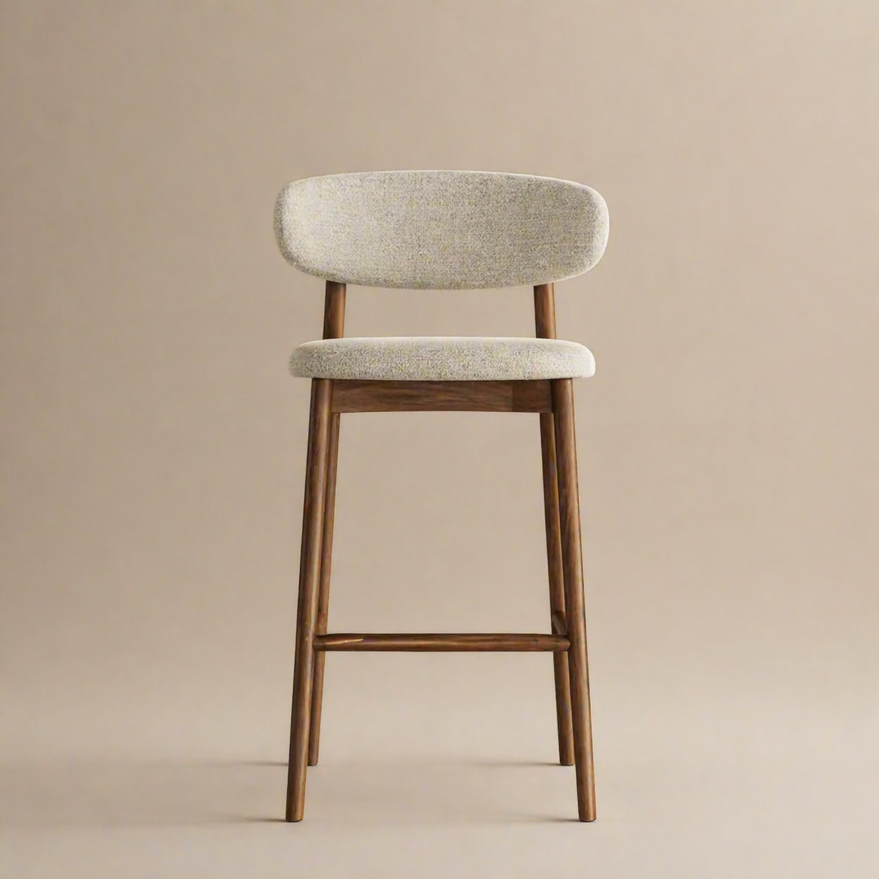 Bar stool with wooden legs and light gray cushioned seat on a beige background