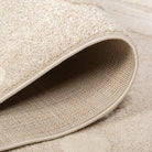 Folded edge of the Little Roar Kids Rug showing its soft pile, bound edge and woven backing.