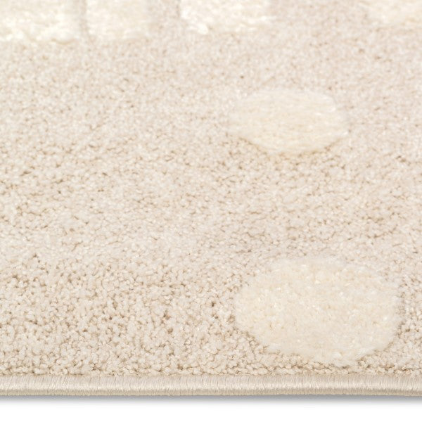 Close-up pile detail of the Little Roar Kids Rug showing soft neutral texture and raised circular accents.