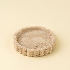 Decorative stone bowl on a beige background