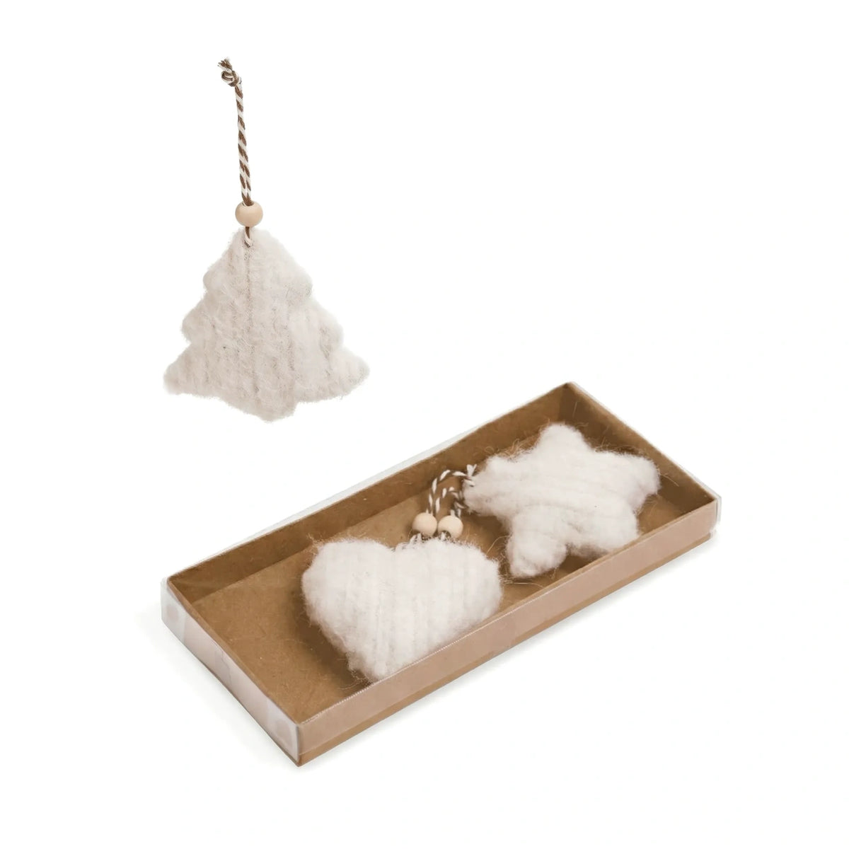 White felted wool Christmas ornaments, including a tree-shaped ornament hanging above and a pair of heart and star-shaped ornaments inside a brown cardboard gift box below, on a white background.