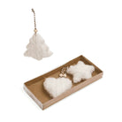 White felted wool Christmas ornaments, including a tree-shaped ornament hanging above and a pair of heart and star-shaped ornaments inside a brown cardboard gift box below, on a white background.