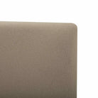 Close-up of the Lunelle Velvet Bed in Tan, upholstered headboard corner on a white background