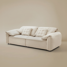 Beige sofa with quilted cushions on a beige background
