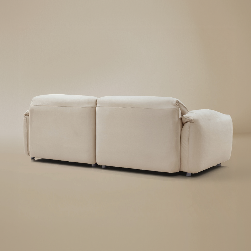 Beige sofa with quilted cushions on a beige background