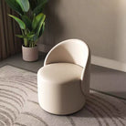 Curved vanity stool upholstered in beige vegan leather