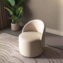 Curved vanity stool upholstered in beige vegan leather