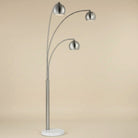 Three-arm floor lamp with silver finish on a beige background